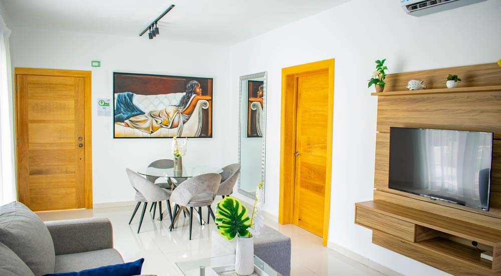 Living room with sofa and dining area in Beach Apartamentos in Playa Palmera 